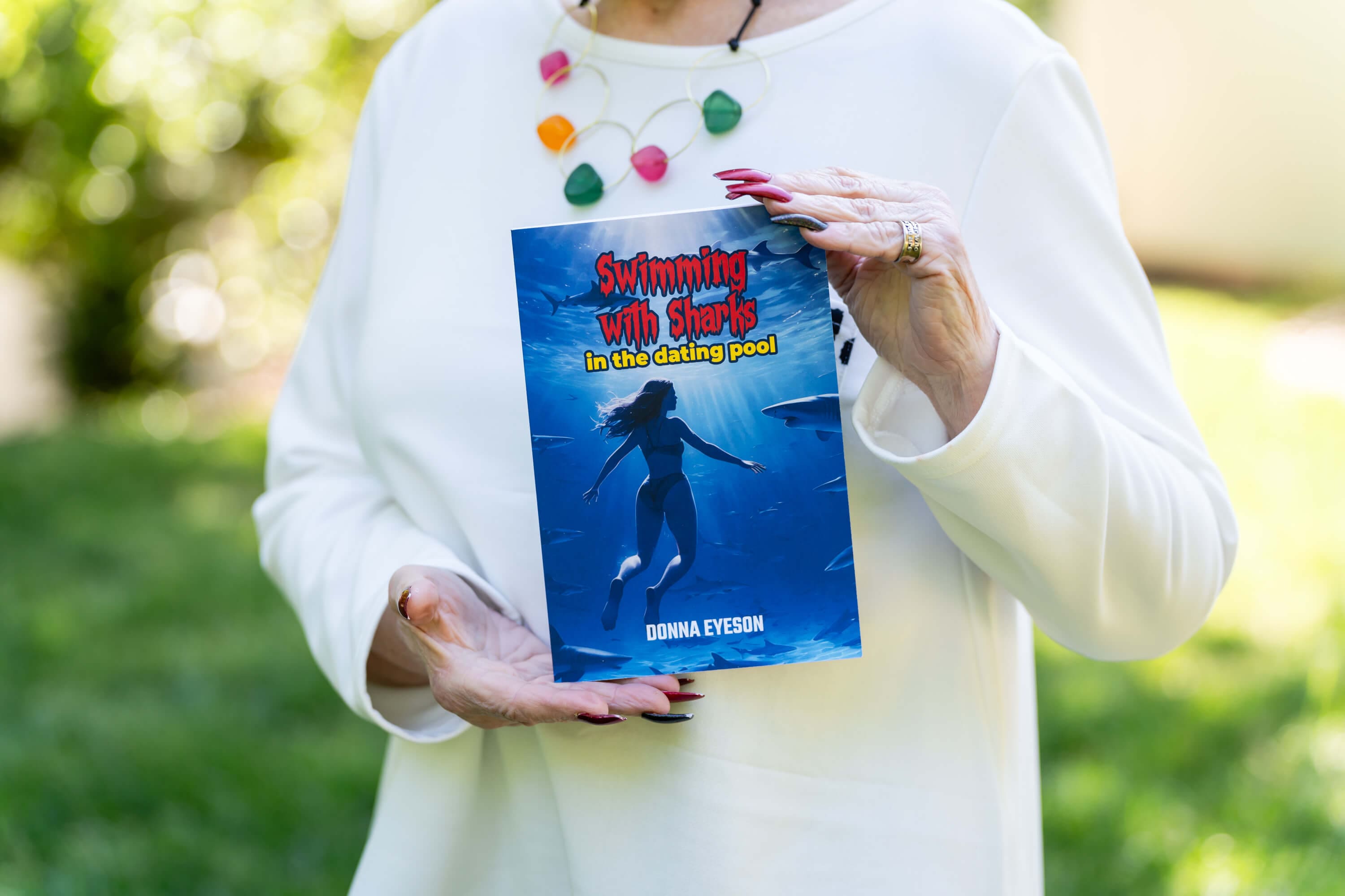 A woman holding an altered book in her hands.